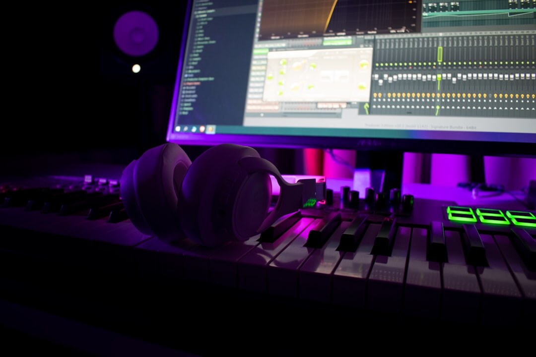 Audio mixing desk with waveform editing software and studio headphones